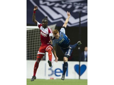 VANCOUVER June 18 2016. Whitecaps FC #26 Tim Parker and New England Revolution #13 Kel Kamara after a header in a regular season MLS soccer game at BC Place, Vancouver June 18 2016.( Gerry Kahrmann  /  PNG staff photo)   ( For Sun / Prov Sports ) 00043798A [PNG Merlin Archive]