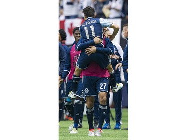 VANCOUVER June 18 2016. Whitecaps FC #11 Nicolas Mezquida jumps into the arms of #27 Blas Perez after scoring on the New England Revolution in a regular season MLS soccer game at BC Place, Vancouver June 18 2016.( Gerry Kahrmann  /  PNG staff photo)   ( For Sun / Prov Sports ) 00043798A [PNG Merlin Archive]