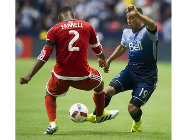 VANCOUVER June 18 2016. Whitecaps FC #19 Erik Hurtado works to get the ball past New England Revolution #2 Andrew Farrell is a regular season MLS soccer game at BC Place, Vancouver June 18 2016.( Gerry Kahrmann  /  PNG staff photo)   ( For Sun / Prov Sports ) 00043798A [PNG Merlin Archive]