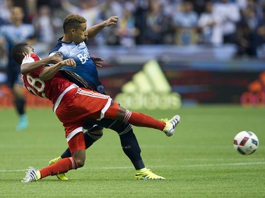 VANCOUVER June 18 2016. Whitecaps FC #19 Erik Hurtado is tackled by New England Revolution #28 London Woodberry in a regular season MLS soccer game at BC Place, Vancouver June 18 2016.( Gerry Kahrmann  /  PNG staff photo)   ( For Sun / Prov Sports ) 00043798A [PNG Merlin Archive]