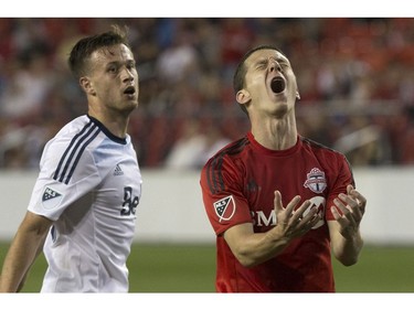 Toronto FC's Will Johnson, right, reacts after sending a shot narrowly wide of the Vancouver Whitecaps goal during second half Canadian Cup action in Toronto on Tuesday June 21, 2016.