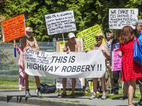 A group protests the relocation of a bus stop near the entrance to Wreck Beach on Marine Drive Drive in Vancouver, B.C. Sunday June 5, 2016.