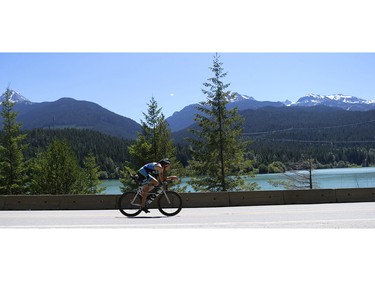 A cyclist passes Green Lake the 2016 Ironman Canada in Whistler, B.C.