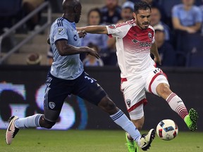 D.C. United forward Fabian Espindola, right, is challenged by Sporting Kansas City defender Ike Opara (3) during the first half of an MLS soccer match in Kansas City, Kan., Friday, May 27, 2016. ) ORG XMIT: KSOW101