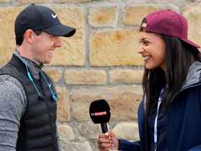 Rory McIlroy of Northern Ireland gets interviewed by a TV reporter on Wednesday, the day before the opening round of the Open Championship at Royal Troon in Troon, Scotland.