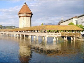 The 14th-century Chapel Bridge zigzags its way across the Reuss River in Lucerne, Switzerland. Cameron Hewitt