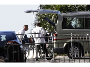 A body is loaded into hearse after a truck plowed into the crowd in Nice, southern France, Friday July 15, 2016.  A large truck plowed through revelers gathered for Bastille Day fireworks in Nice, killing more than 80 people and sending others fleeing into the sea as it bore down for more than a mile along the Riviera city's famed waterfront promenade.