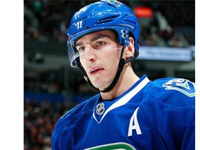 Alexandre Burrows #14 of the Vancouver Canucks looks on from the bench during their NHL game against the Florida Panthers at Rogers Arena January 11, 2016 in Vancouver, British Columbia, Canada.