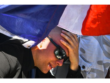 A man reacts as people visit the scene and lay tributes to the victims of a terror attack on the Promenade des Anglais on July 15, 2016 in Nice, France. A French-Tunisian attacker killed 84 people as he drove a lorry through crowds, gathered to watch a firework display during Bastille Day Celebrations. The attacker then opened fire on people in the crowd before being shot dead by police.