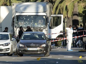 Forensic police on Friday investigate a truck at the scene of a terror attack on the Promenade des Anglais in Nice, France. A French-Tunisian attacker killed 84 people as he drove the truck through crowds.