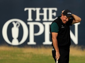 Phil Mickelson reacts after his birdie putt narrowly missed the hole on the 18th during the first round of the 145th Open Championship at Royal Troon in Scotland on Thursday. Mickelson became the 28th man to shoot a 63 in a major.