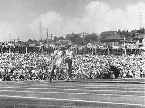 Roger Bannister (left) streaks by John Landy, who's looking for him over his left shoulder. Bannister wins, and both men break the four-minute mile at the 1954 Empire Games in Vancouver.