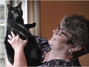 Lisa Adams, an "End of Life Midwife", at her home in Burnaby with her cat. She offers emotional support to people who are dying and practical support for the loved ones who want to care for them.