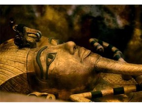FILE - In this Thursday, Nov. 5, 2015 file photo, one of Egypt's famed King Tutankhamun's golden sarcophagus is displayed at his tomb in a glass case at the Valley of the Kings in Luxor. Egypt's Antiquities Minister Mamdouh el-Damaty, says during a press conference Thursday, March 17, 2016, that analysis of scans of famed King Tut's burial chamber has revealed two hidden rooms that could contain metal or organic material. (AP Photo/Amr Nabil)