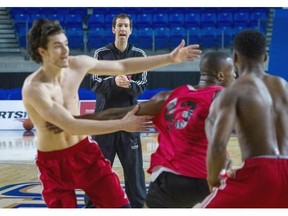 Carleton Ravens’ interim head coach Rob Smart instructs players during practice Wednesday before the CIS men’s basketball championship Final 8 tournament at the Doug Mitchell Thunderbird Sports Centre at the University of British Columbia.