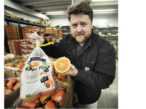 Damien Bryan, general manager for Discovery Organics, with a bag of “ugly” oranges.