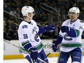 Daniel Sedin #22 of the Vancouver Canucks is congratulated by Jannik Hansen #36 after he scored a goal against the San Jose Sharks at SAP Center on March 31, 2016 in San Jose, California.