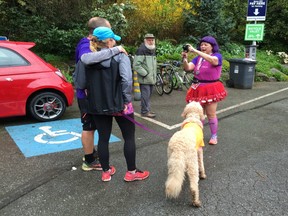 Size matters when training dogs, with research suggesting smaller ones can often be more difficult. Vancouver runner Debra Kato was thrilled to see this big dog 'pose' when she took this couple's photo after a recent race in Stanley Park.