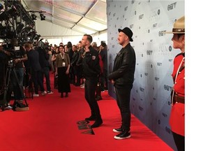 Rapper SonReal and girlfriend Sheena Main pose for photos on the red carpet.