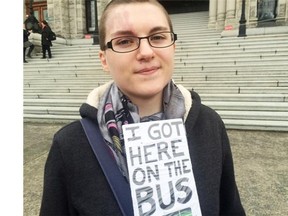 Eryn Ralston, who has PTSD and other problems, and receives disability assistance, attends a protest wearing a placard with her bus pass in Victoria on Wednesday March 2, 2016.