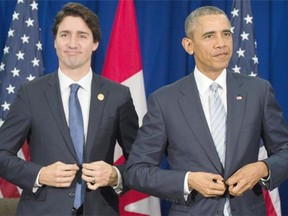 File: U.S. President Barack Obama and Canadian Prime Minister Justin Trudeau (L) button their jackets as they leave their bilateral meeting on the sidelines of the Asia-Pacific Economic Cooperation (APEC) Summit in Manila on November 19, 2015. Police and protesters clashed on November 19 outside the gathering of Asia-Pacific leaders who were meeting for a summit dominated by a US-China tussle for regional influence.