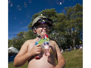 Anthony Joyce, age 8, from Langley makes bubbles as he waits to watch Team Australia compete in the  Honda Celebration of Light fireworks display, Vancouver, July 27 2016.