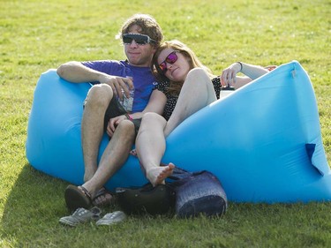 Jonathan Phillips and Heather McGinty lounge on an inflatable sofa at the main stage at the 39th annual Folk Music festival Jericho Beach Vancouver, July 15 2016.