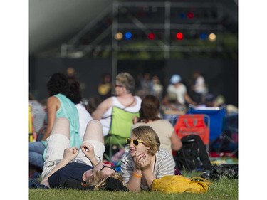 A couple listens to Jolie Holland and Samantha Parton perform on the main stage at the 39th annual Folk Music festival Jericho Beach Vancouver, July 15 2016.