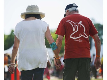 A couple walks to the main stage at the 39th annual Folk Music festival Jericho Beach Vancouver, July 15 2016.