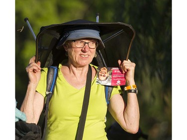 A woman carries her chair the main stage at the 39th annual Folk Music festival Jericho Beach Vancouver, July 15 2016.