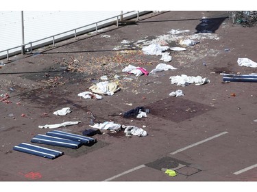 This picture taken on July 15, 2016, shows the site where a truck drove into a crowd watching a fireworks display on the Promenade des Anglais seafront in the French Riviera town of Nice on July 15, 2016. An attack in Nice where a man rammed a truck into a crowd of people left 84 dead and another 18 in a "critical condition", interior ministry spokesman Pierre-Henry Brandet said Friday. An unidentified gunman barrelled the truck two kilometres (1.3 miles) through a crowd that had been enjoying a fireworks display for France's national day before being shot dead by police.