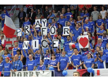 French fans show "Pray for Nice" banners to honor victims of the Bastille Day attack in Nice prior to the tennis Davis Cup quarterfinal match between Czech Republic and France in Trinec, Czech Republic, on Friday, July 15, 2016.