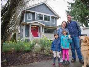 Geoff Glave and Ana-Maria Hobrough pose with their two children and pet dog outside their renovated home in Vancouver.