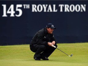 Phil Mickelson lines up a putt on the 18th green as he shoots his way to a second-round 69 at the Open Championship on Friday in Troon, Scotland. Mickelson, who has a one-shot lead over Henrik Stenson going into the weekend, is halfway to becoming the oldest Open champion — at 46 years and 29 days — since Old Tom Morris in 1867.