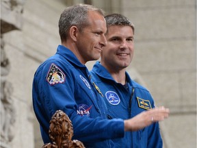 Canadian astronauts Jeremy Hansen, right, and David Saint-Jacques stand in the visitors' gallery in the House of Commons at Ottawa in June 2015. Canada is looking for two more astronauts.