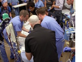Medical staff try to save a patient in the emergency room of Vancouver General Hospital.