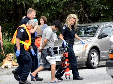 A man was led away in handcuffs after a house fire in Port Moody around 1:30 p.m. Sunday, July 10 in the 3300-block of Dewdney Trunk Rd. Seven people were taken to hospital, including two adults and five children.