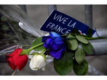 A sign reading "Long live France" is placed near roses in the colors of the French flag at a makeshift memorial in front of the French Embassy in Rome on July 15, 2016, in honour of the victims of an attack in Nice the day before that left at least 84 people dead. A Tunisian-born man zigzagged a truck through a crowd celebrating Bastille Day in the French city of Nice, killing at least 84 and injuring dozens of children in what President Francois Hollande on July 15 called a "terrorist" attack.