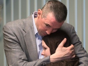 John Nuttall, back, and Amanda Korody embrace each other at B.C. Supreme Court after a judge ruled the couple were entrapped by the RCMP in a police-manufactured crime, in Vancouver on Friday, July 29, 2016.