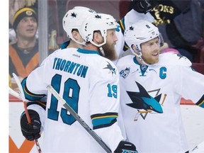 San Jose Sharks’ Joe Pavelski, right, Joe Thornton, front left, and Tomas Hertl, of the Czech Republic, celebrate Pavelski’s goal against the Vancouver Canucks during the second period of an NHL hockey game in Vancouver, B.C., on Tuesday March 29, 2016.