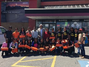 Surrey businessman Dave Mann, centre, treated Team India to new cleats at a Surrey sporting goods store.