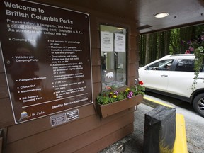 Campers enter Alouette Lake in Golden Ears Provincial Park near Maple Ridge.