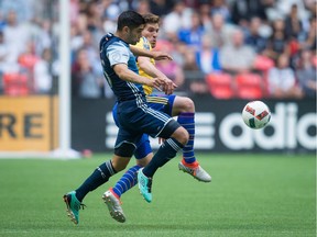 Vancouver Whitecaps' Matias Laba, left, and Colorado Rapids' Dillon Powers vie for the ball during first half MLS soccer action in Vancouver, B.C., on Saturday, July 9, 2016.