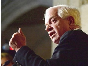 Minister of Immigration, Refugees and Citizenship John McCallum speaks to reporters in the foyer of the House of Commons, in Ottawa, on November 9, 2015. A government document obtained by The Canadian Press that lays out the proposed funding model says $876.7 million would be needed in 2015-2016 alone to help resettle the Liberal government's target of 25,000 Syrian refugees. THE CANADIAN PRESS/Sean Kilpatrick