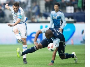 Montreal Impact’s Ignacio Piatti, left, of Argentina, scores a goal as Vancouver Whitecaps’ Kendall Waston, of Costa Rica, defends during first half MLS soccer action, in Vancouver on Sunday, Mar. 6, 2016.