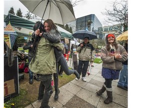Hunger striker Kristin Henry gets hugs outside BC Hydro headquarters in downtown Vancouver.