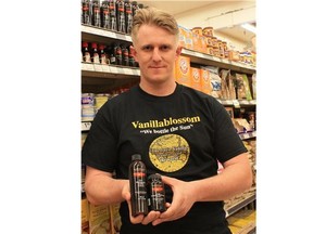 VICTORIA, BC: March 31, 2015 -- Dave Best, owner of Vanillablossom Flavors, holds bottles of his pure Madagascar vanilla extract and paste. Best says the cost of beans has nearly tripled over the past year. --Submitted Photo: Nancy Patino for Vanillablossom Flavors (for story by Nick Eagland)