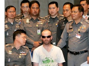Christopher Paul Neil, 32, is surrounded by Thai policemen in 2007.