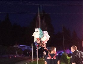 Photos show the man suspended in mid-air, tangled up in his equipment and hanging by the paraglider’s cords over electrical lines near Montroyal Boulevard and Ranger Avenue.