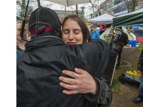 Hunger striker Kristin Henry gets hugs outside BC Hydro headquarters in Vancouver during a protest of the Site C dam.